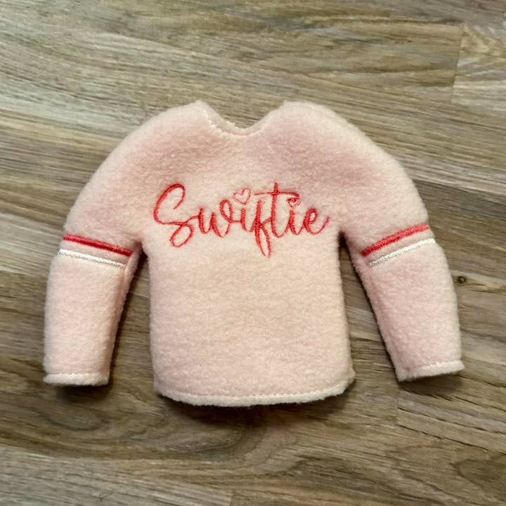 light pink Swiftie Elf sweater  for wholesale by Lilies & Lark Boutique