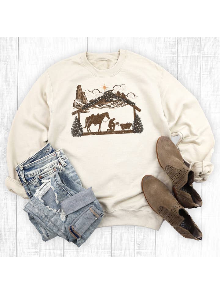 Sand Christmas Manger Praying Cowboy Sweatshirt for wholesale on Faire