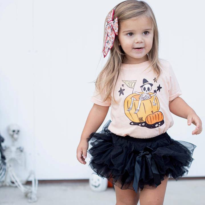 Pumpkin Skelly graphic for wholesale by AK CLOTHING COMPANY, LLC