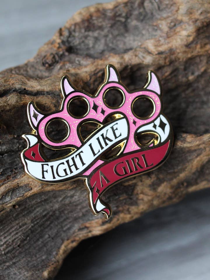 Feminist knuckleduster feminine rage enamel pin for wholesale by Geek and Artsy
