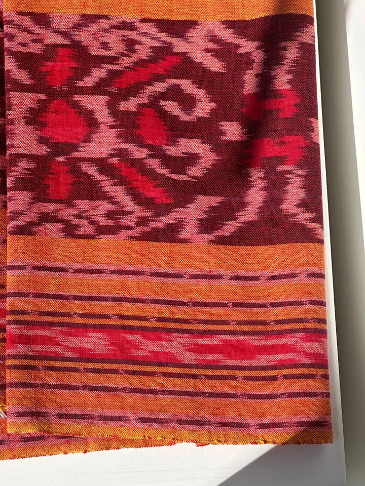 Indonesian ikat predominantly orange, traditional fabric 185x40cm for wholesale by Office Objets