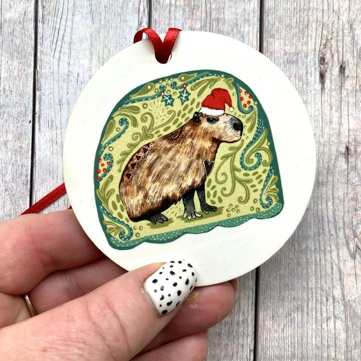 Capybara in a Santa Hat Christmas Ornament (Copy) for wholesale by Slumbermonkey Designs