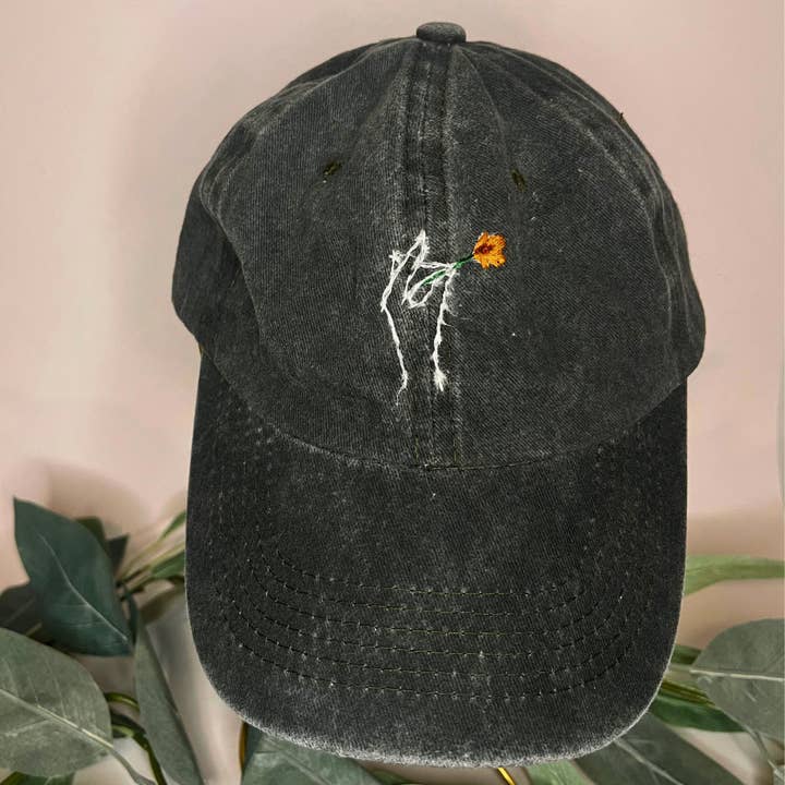 Green Baseball Hat | Hand Holding a Flower | Embroidered Hats for wholesale by Thread & Ember