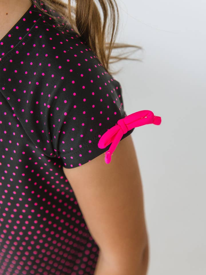 Girls Black & Neon Magenta Tiny Dots Active Raglan Bow Shirt
for wholesale by RuffleButts + RuggedButts