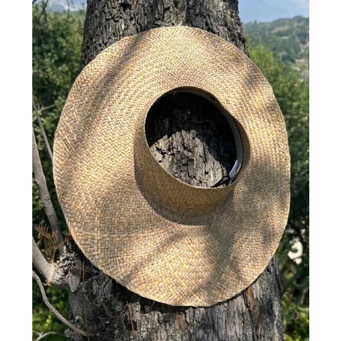 HANDWOVEN NATURAL STRAW CROWNLESS HAT for wholesale on Faire7