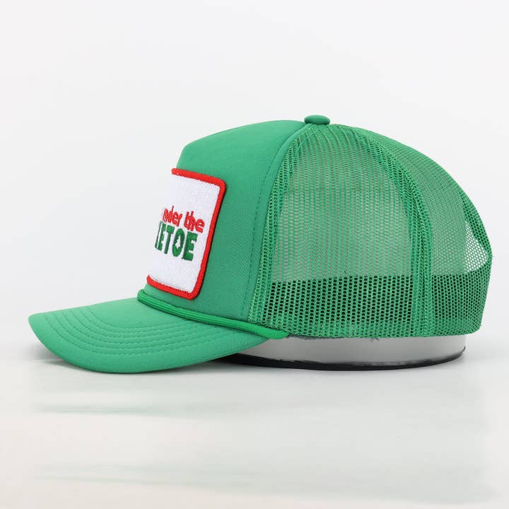 Meet Me Under The Mistletoe Trucker Hat in Green for wholesale on Faire4