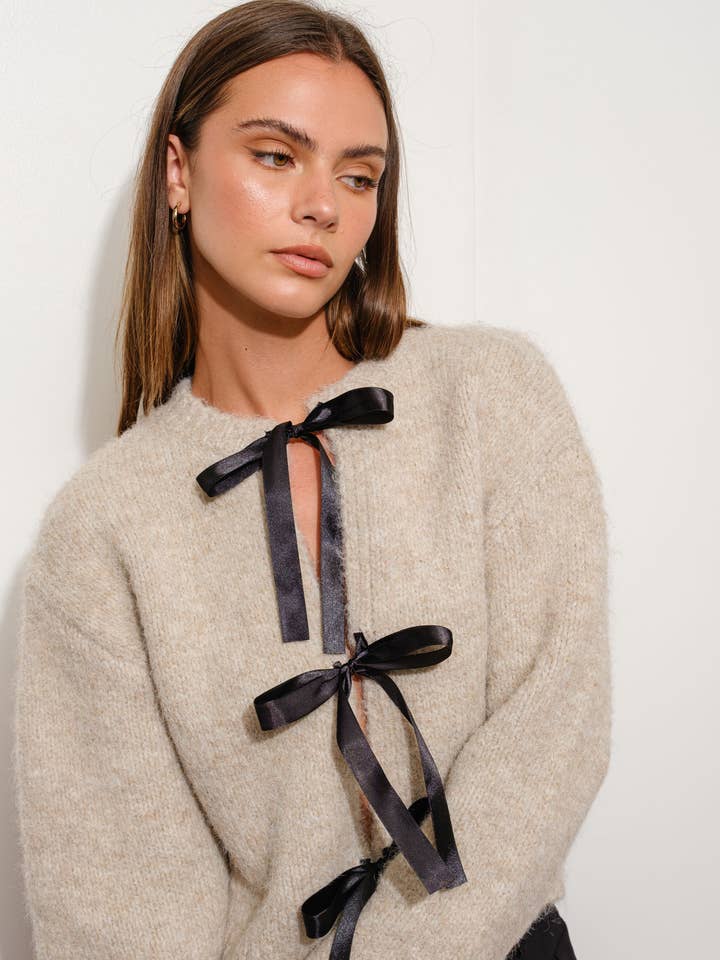 SAND SATIN BOW CARDIGAN for wholesale on Faire
