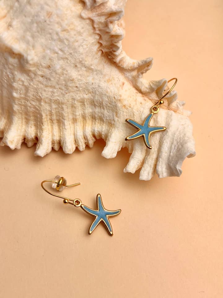 Blue lagoon starfish earrings in steel for wholesale by COSMOS
