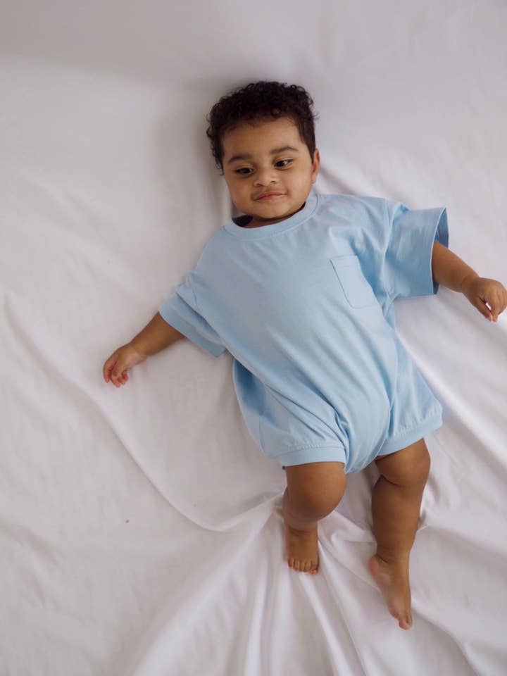 Cory Pocket Romper in Dream Blue for wholesale by Winnie + Crew