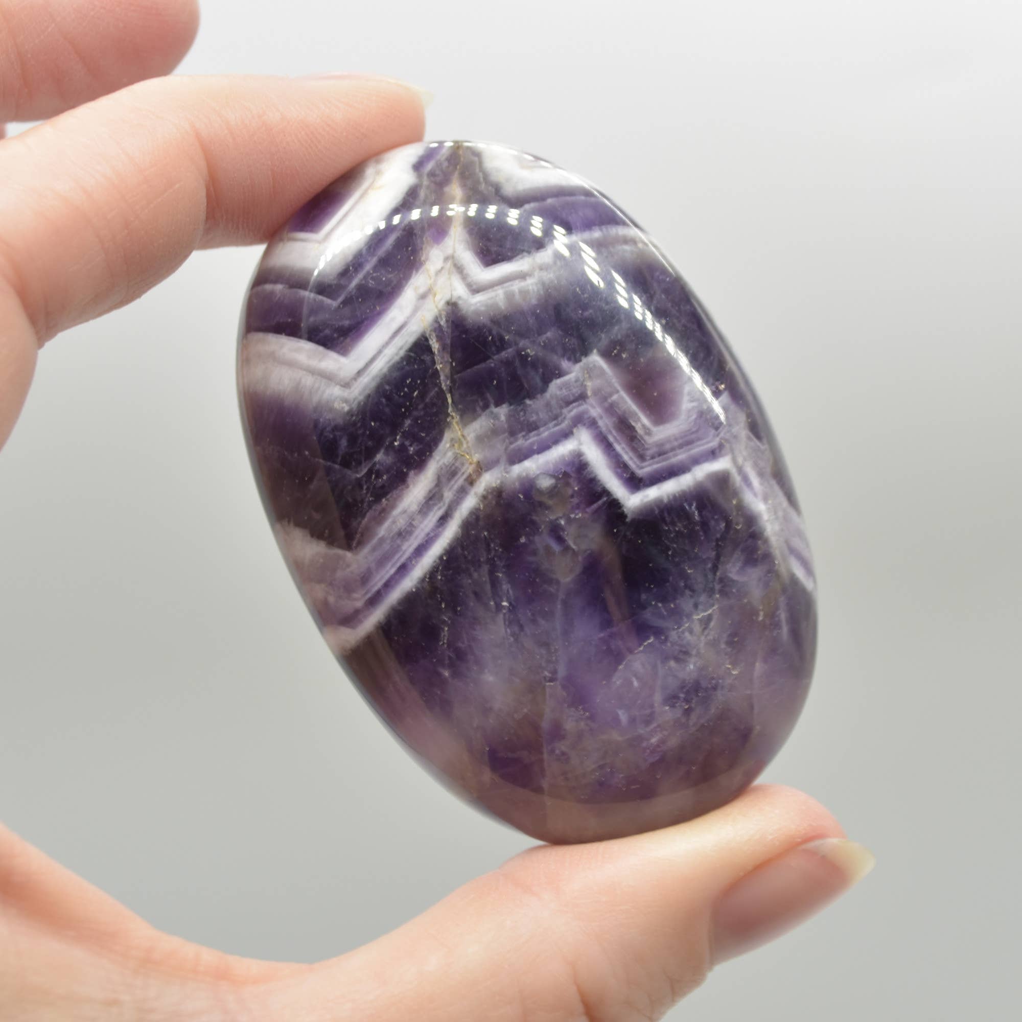 Purple Chevron Amethyst Crystal Palm Stone - 6 cm - 1 Count for wholesale on Faire2