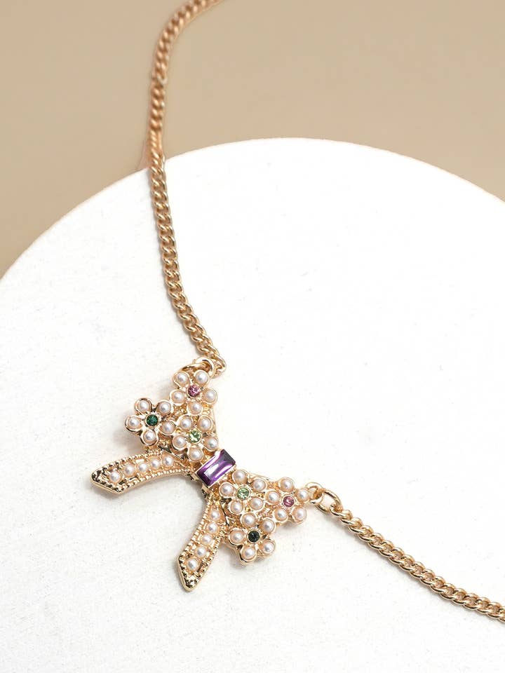 PEARL RHINESTONE PAVE BOW CHARM NECKLACE | 31N50315 for wholesale by JOSSLYN by wall to wall