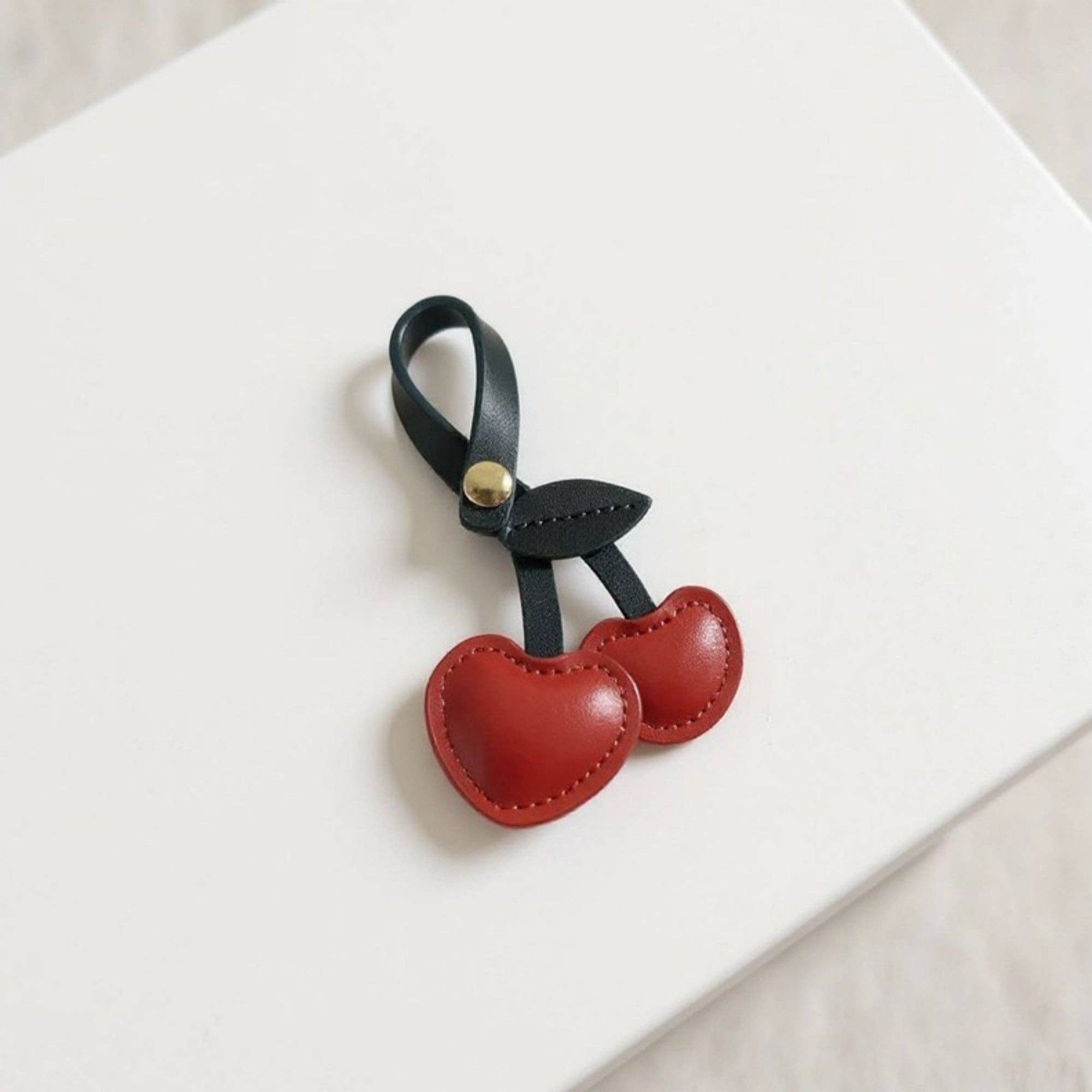 Red Faux Leather Cherry Heart Keychain with Black Leaf Strap and for wholesale on Faire3