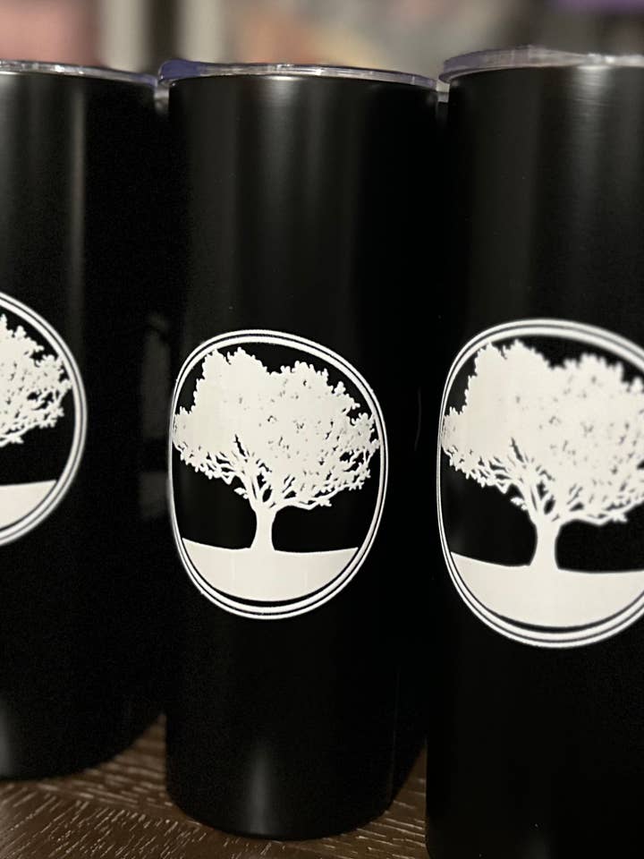 Matte black tumbler with branded logo, lid and straw for wholesale by NRealesDesign