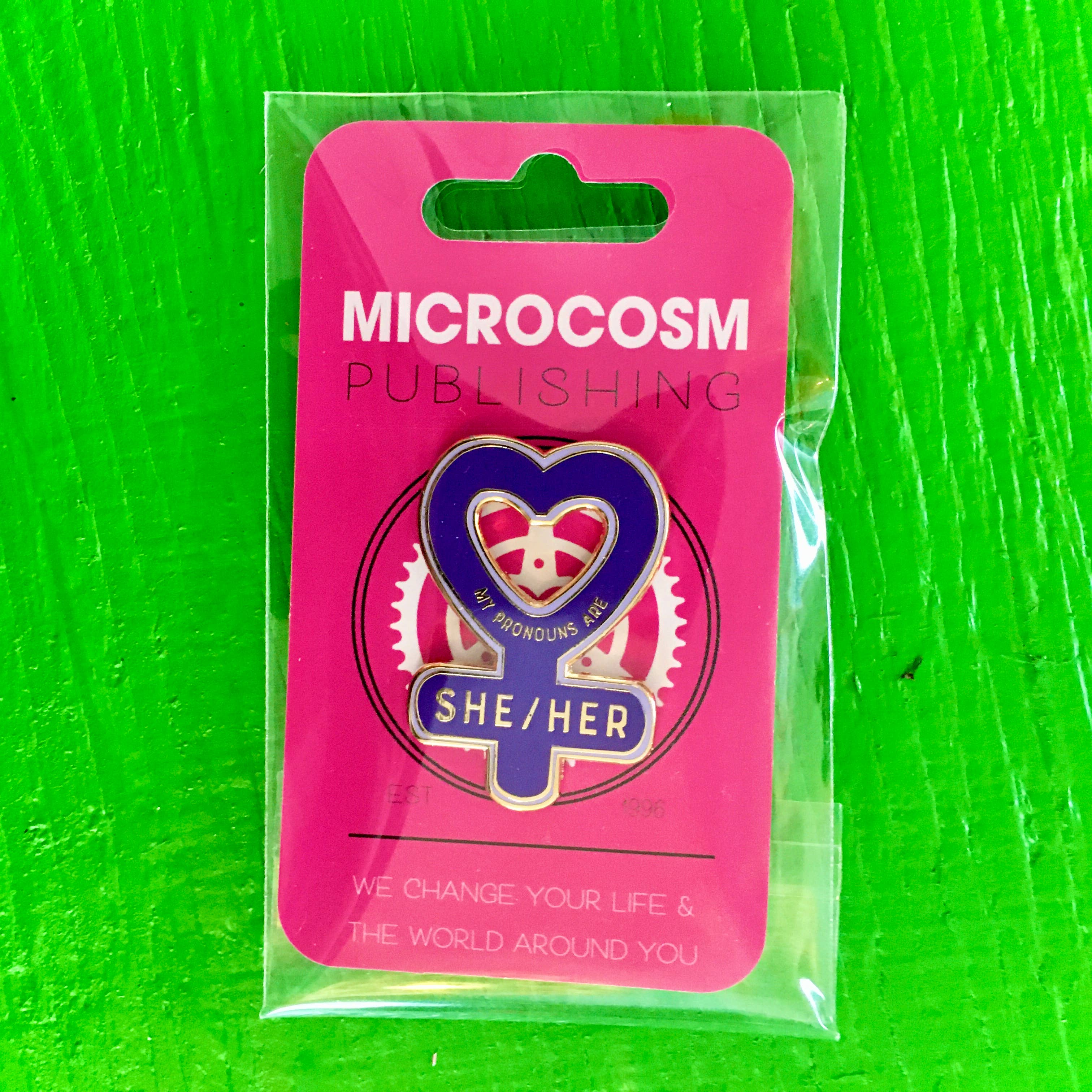 Microcosm Publishing & Distribution – wholesale Lapel pin/button – My Pronouns are She/Her Enamel Pin2