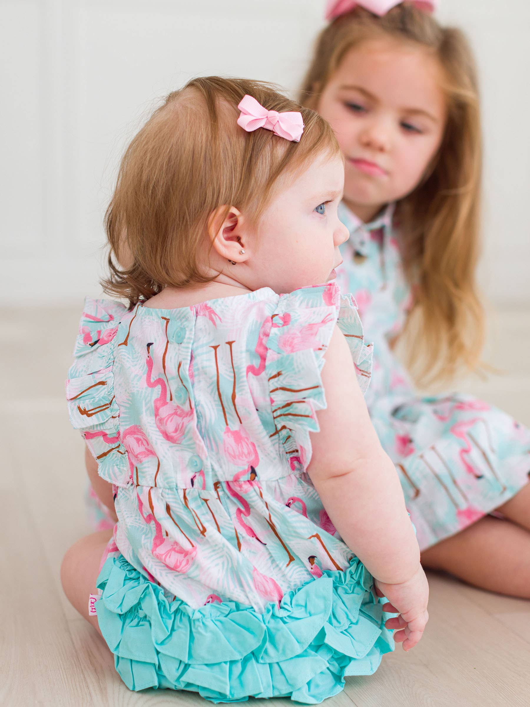 Multi Color Baby Girls Vibrant Flamingo Classic Ruffle Bubble Romper for wholesale on Faire2