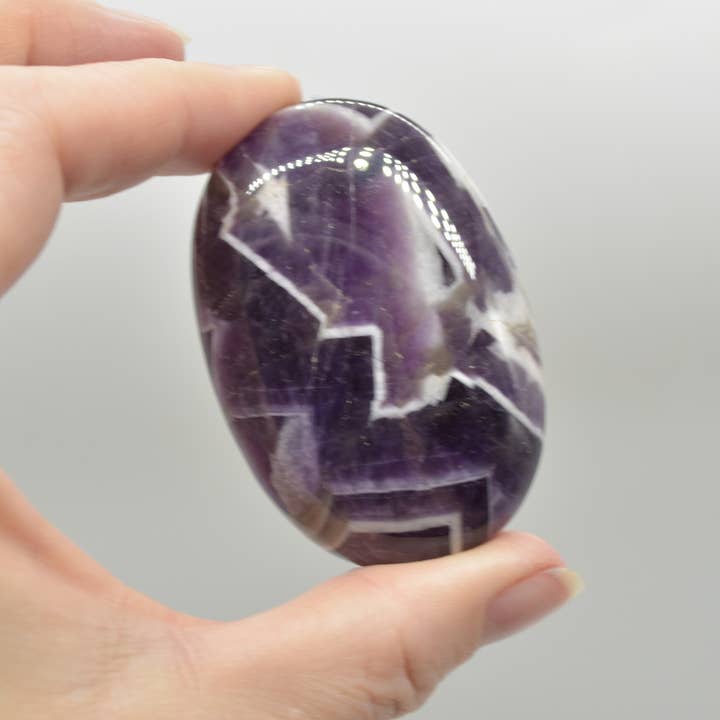 Purple Chevron Amethyst Crystal Palm Stone - 6 cm - 1 Count for wholesale on Faire3