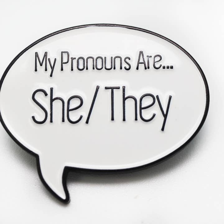 Foam Brain Games - Wholesale Lapel Pin/Button - Speech Bubble Pin: She/They Pronouns