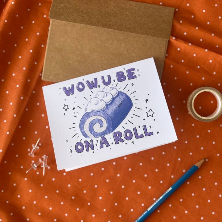 Claudine Castro Art - Wholesale Congratulations Card - Ube Cake U Be On A Roll Congratulations Blank Greeting Card