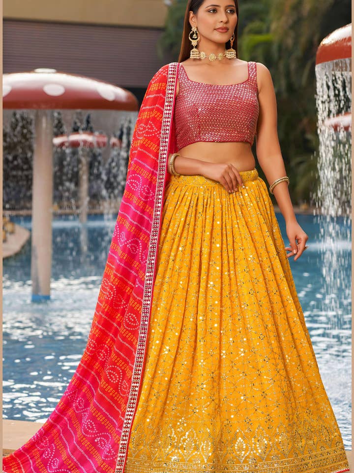 Lehenga Choli in Georgette Gialla per Matrimonio e Festival Indiano e Pakistano - Ricamo con Paillettes e Filo, Lavoro Zari, Lavoro di Stampa per la vendita all'ingrosso da parte di HATKE BRIDE