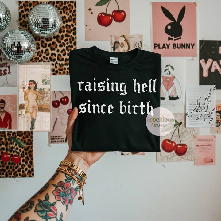 Raisin' Hell Since Birth Graphic T-shirt for wholesale by Rebellious Rose LLC