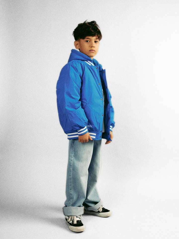 Boys Baseball Style Royal Blue Jacket with White Striped Cuffs for wholesale by Minoti sp. z o.o.