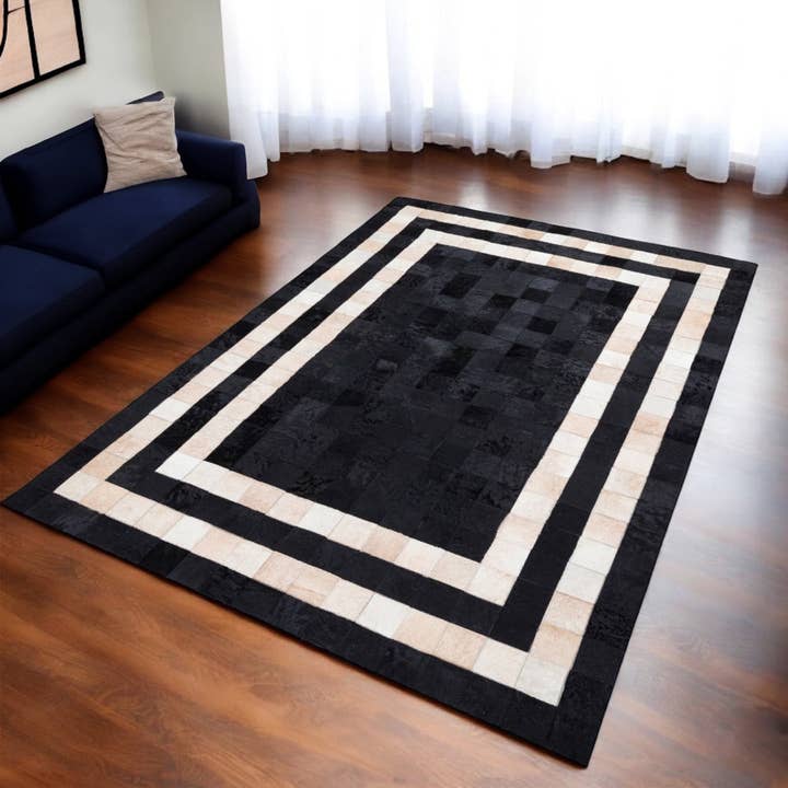 Cream Cowhide Patchwork Rug with Black Frame for wholesale by Karelias And Sons