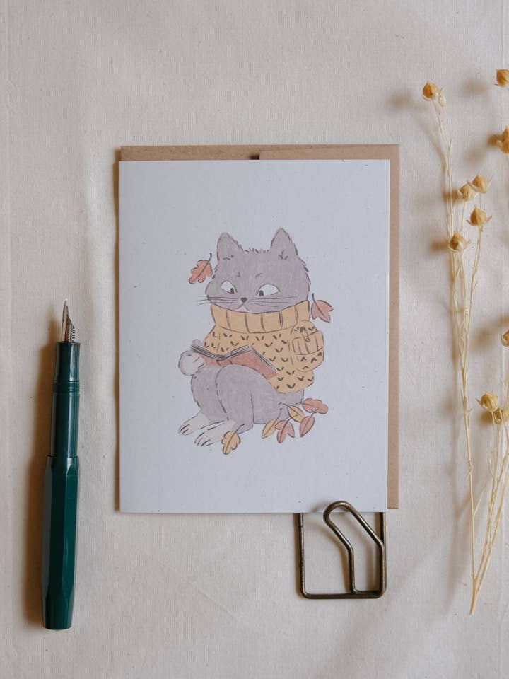 Bookish Cat Greeting Card for wholesale by Justine Gilbuena