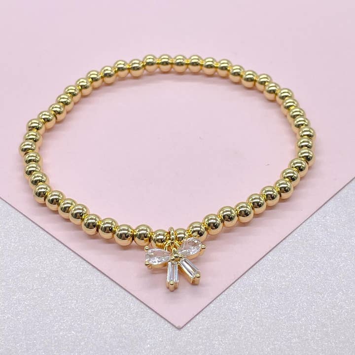 18k GF Elastic 4mm Beaded Bracelet with CZ Bow for wholesale by Milie