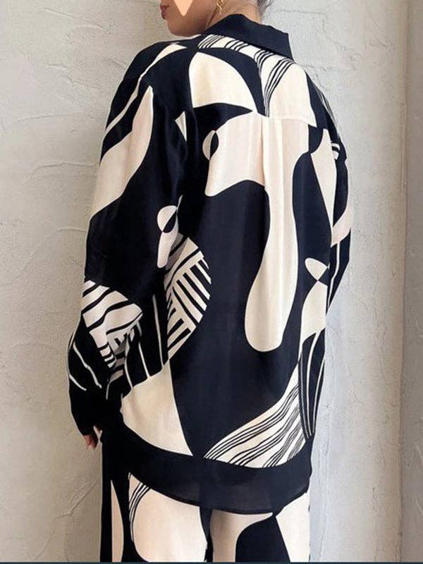 NERO Completo donna con blusa ampia a maniche lunghe e pantaloni con tasche e stampa in vendita all'ingrosso su Faire3