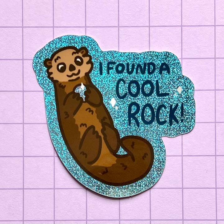 Otter with a Rock Holographic Glitter Sticker for wholesale by 2Birds1Pencil Illustrations
