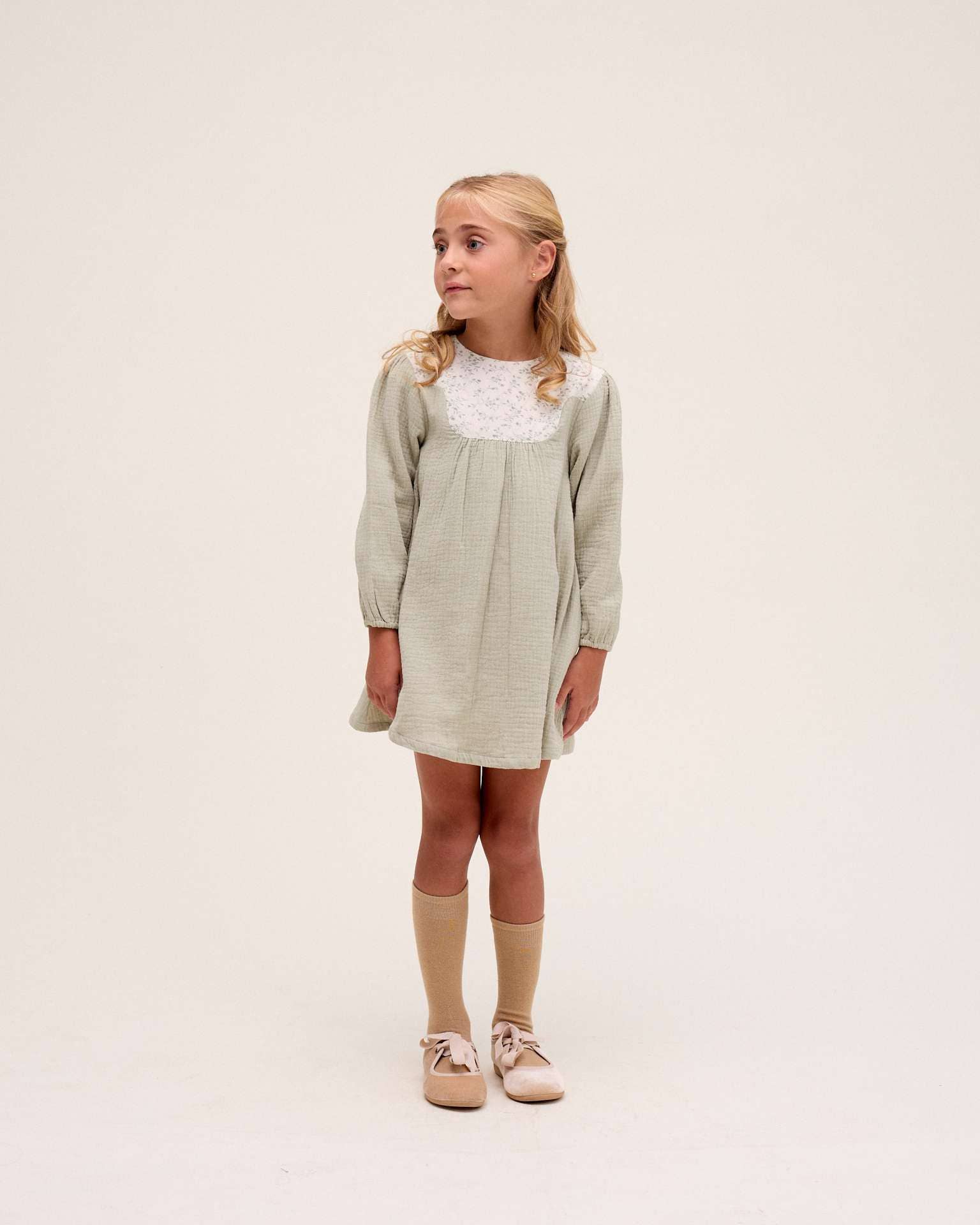 Green muslin girl's dress with floral detail for wholesale on Faire