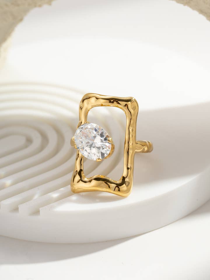 Gold Ring with Transparent Oval Stone Textured Frame Steel for wholesale by COSMOS