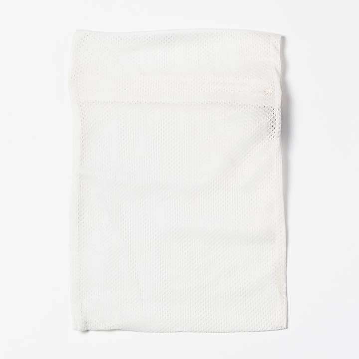 White SHASHI Laundry Bag for wholesale on Faire