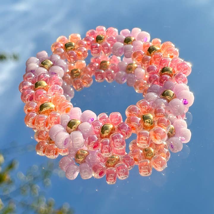 Flower ring "Poppy" made of glass beads in lilac, apricot and pink for wholesale by cool people club
