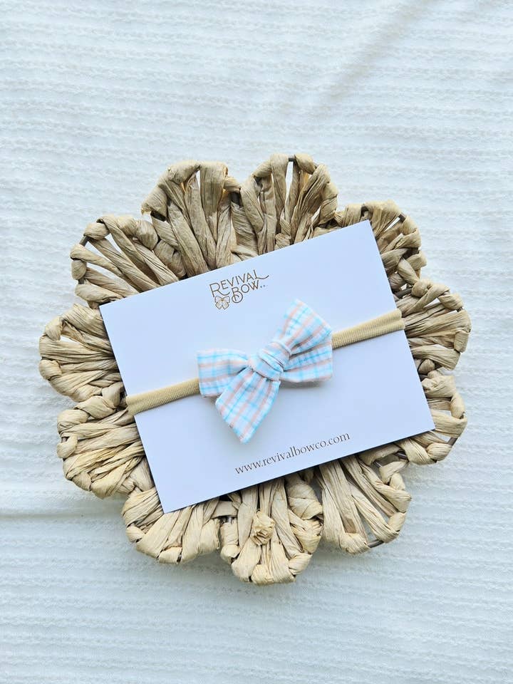 Mini Pinwheel Bow on Headband or Clip • Peach Blue Plaid for wholesale by Revival Bow Co.