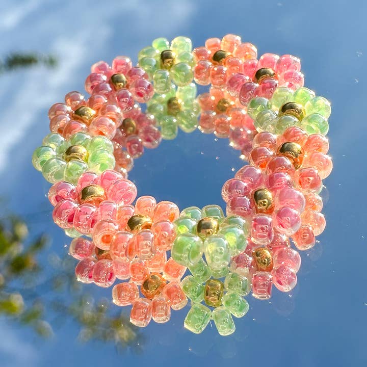 Flower ring "Poppy" made of glass beads in apricot, mint green and pink for wholesale by cool people club