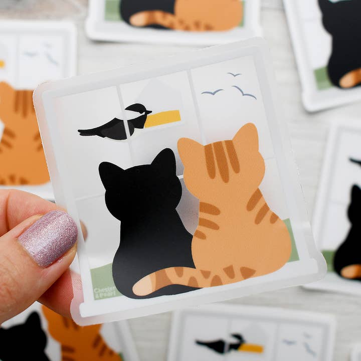 Black and orange bird-watching cats 3-in clear vinyl cat sticker for wholesale by Chester and Pearl