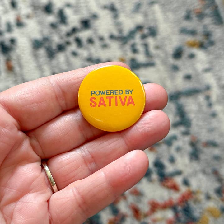 Powered by Sativa Pinback Button for wholesale by Stone Donut Design, LLC