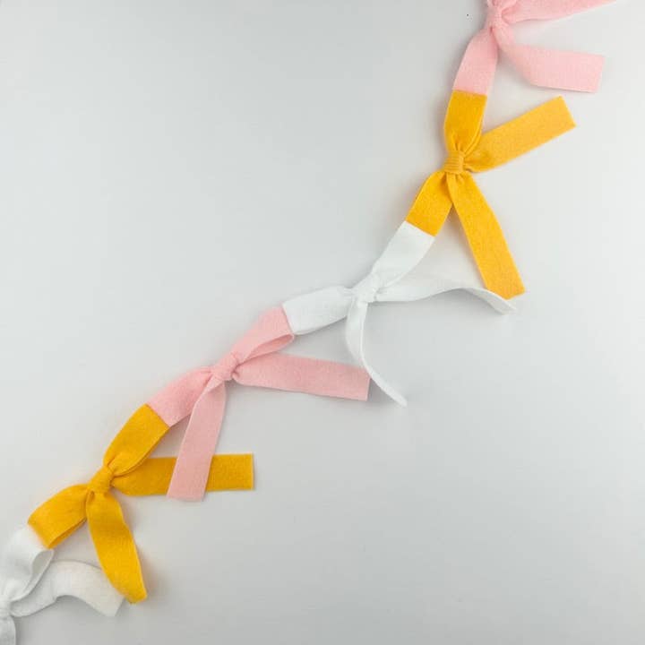 Bow Bunting (white, marigold, light pink) for wholesale by Eventide Pennant Co.
