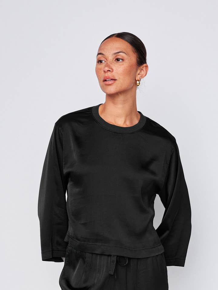 Cosmo Satin Crewneck Top in Black for wholesale by Stateside