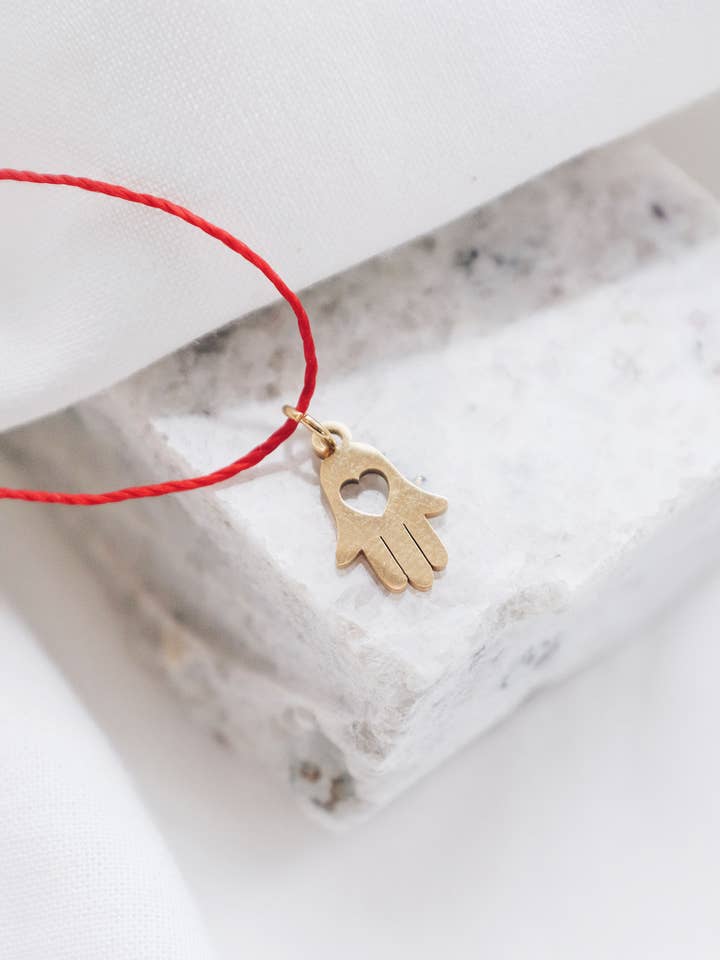 Red String Gold Hamsa Hand Necklace for wholesale by Lyon and Feather