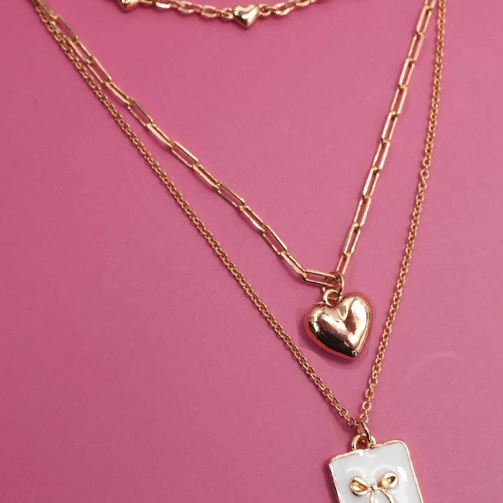 GOLD SQUARE BOW EPOXY CHARM LAYERED NECKLACE | 80N91936 for wholesale on Faire