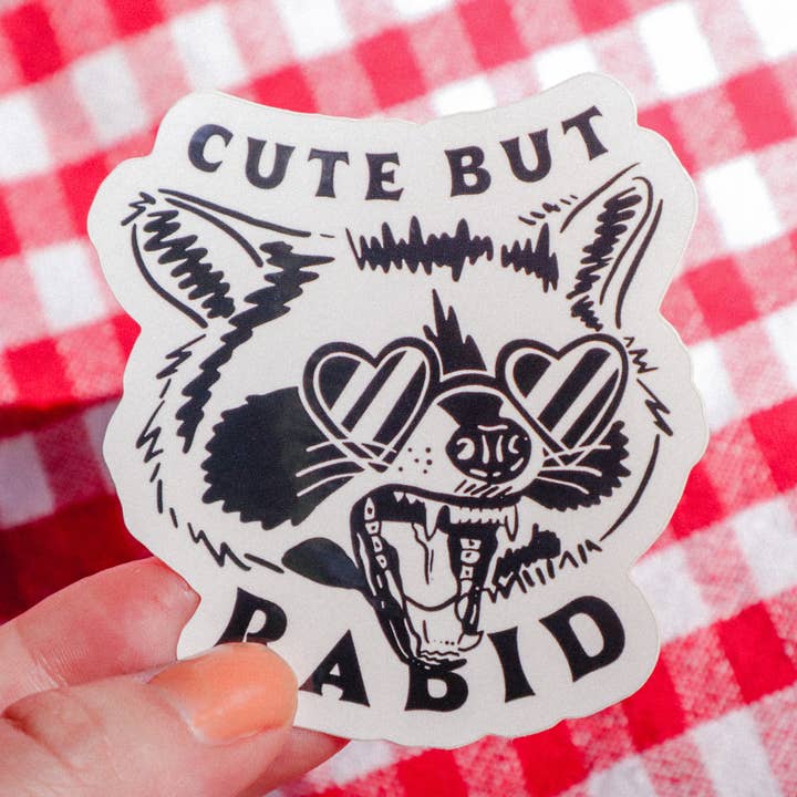 Cute But Rabid Raccoon Sticker for wholesale by Refuge Studios Iowa City