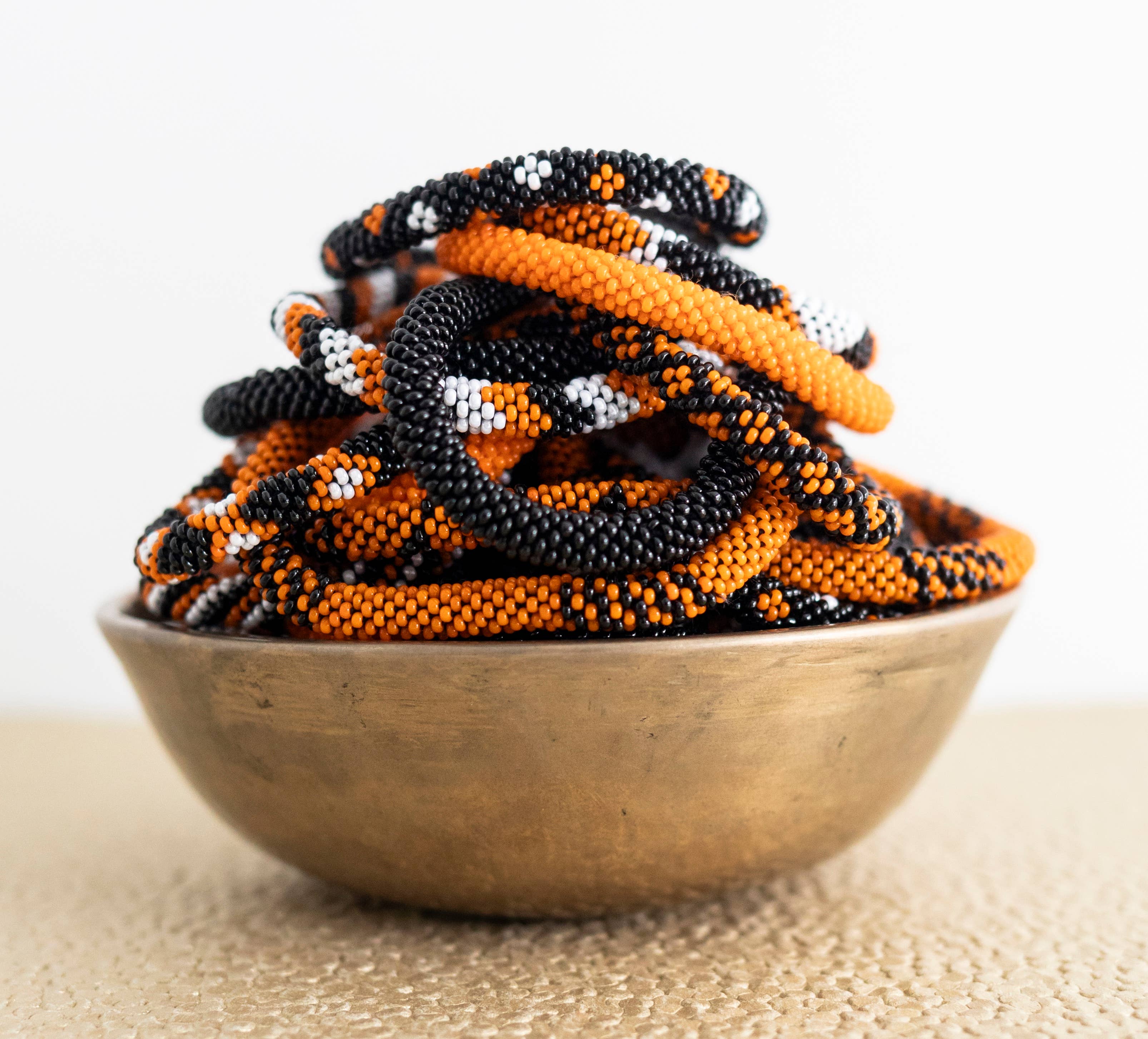 Aid Through Trade – wholesale Beaded bracelet – Halloween Roll-On® Bracelets Orange and Black - Set of 121