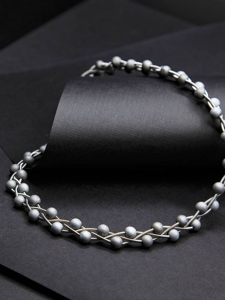 S90A - silver braided piano wire necklace with silver geodes for wholesale by Sea Lily