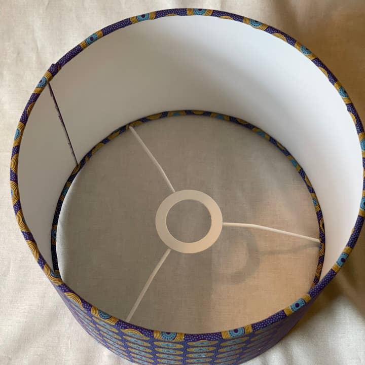 Olive and Limpet - Wholesale Lamp Shade - 10 inch Drum Lampshade. Dynamic South African Shwe Shwe Print- Purple with Teal and Yellow "LP" Motif