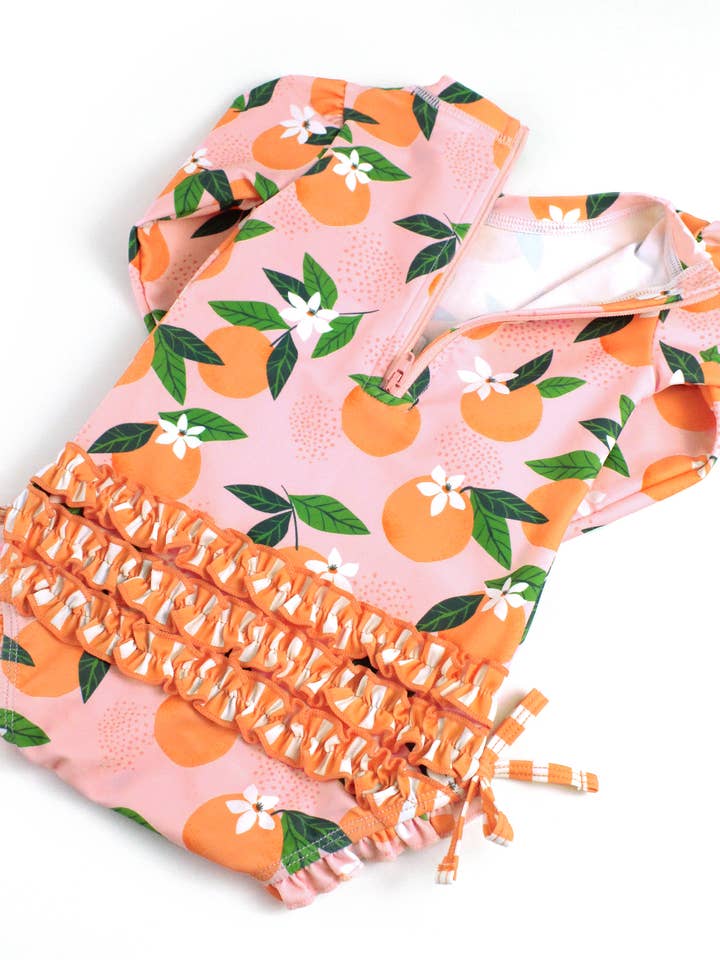 Rosa Bebisflickor Orange You The Sweetest Långärmad Enstycks Rash Guard Baddräkt med Signatur Bakvolanger för wholesale på Faire7