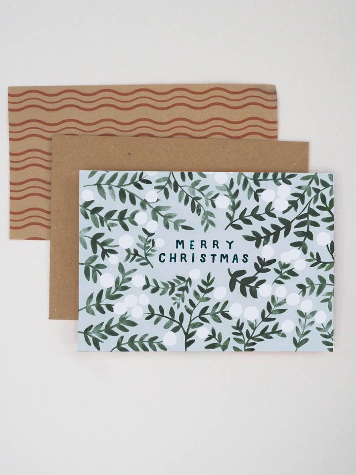 Frohe Weihnachtskarte mit grünem Mistelzweig für den Großhandel von Jade Fisher