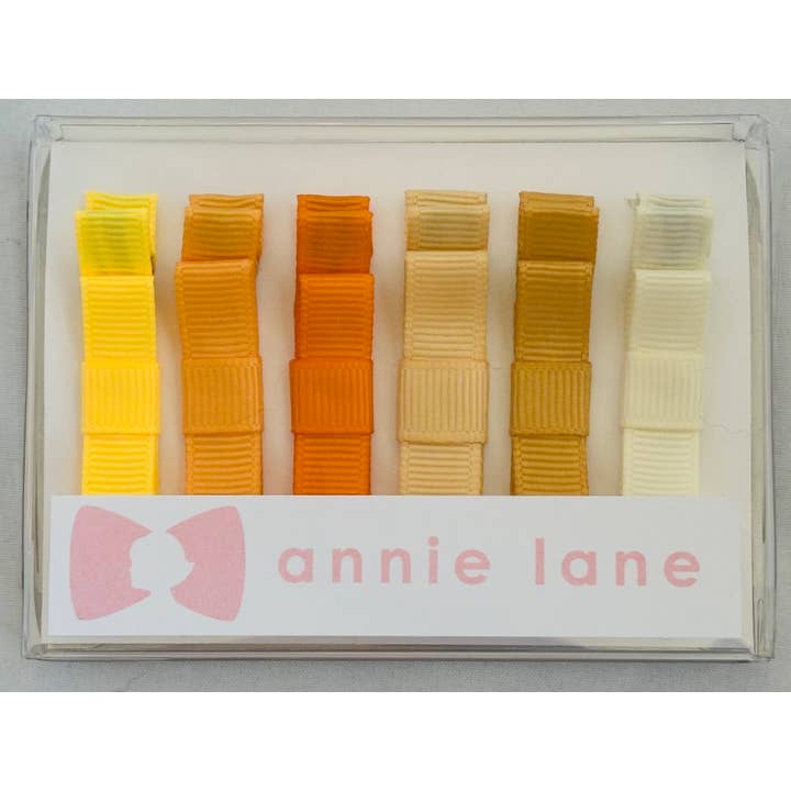 Låda med 6 hårrosetter - guldsolida för wholesale av Annie Lane