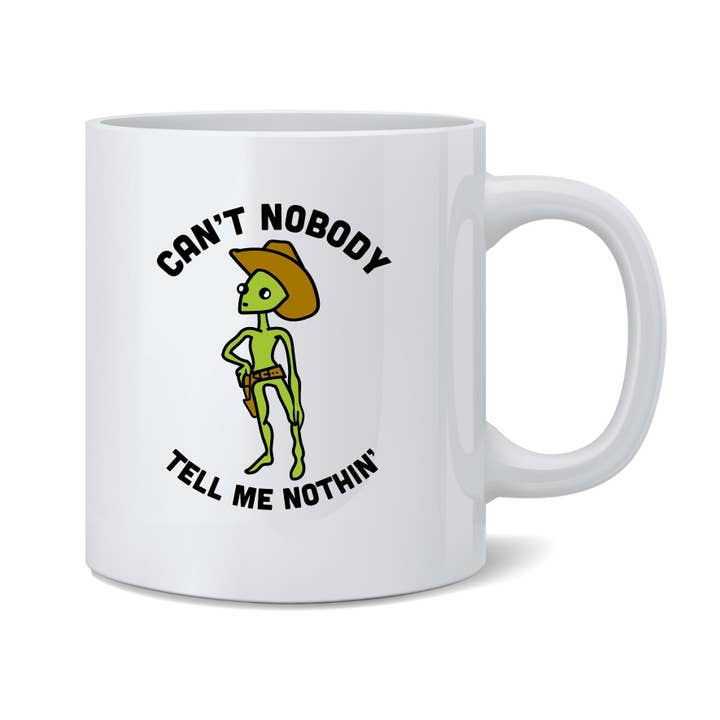 Kan niemand me niets vertellen in Cowboy Alien Area 51 meme-mok voor wholesale door Gotham Gifts